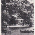 Lake Como, Italy as shown on a black and antique postcard. People enjoy time boating on the lake.